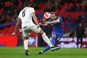 Harry Kane of England shoots whilst under pressure from Kastriot Dermaku of Albania in the 2022 Fifa World Cup qualifier match at Wembley Stadium in London on November 12 2021.