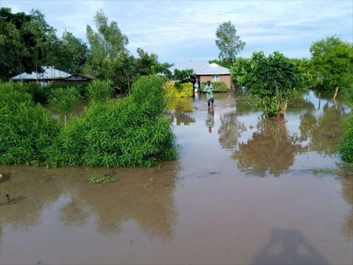 A resident wades through floodwaters in Nyando on December 12 last year