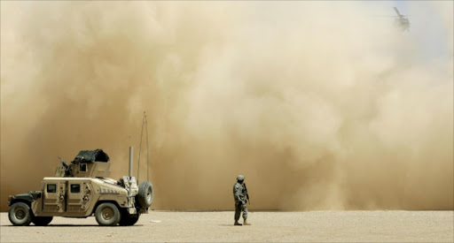 A U.S. military helicopter blasts dust as it lands near the site of a suicide truck bombing in the village of Qahtaniya, 120 kilometers (75 miles) west of Mosul, Iraq, Sunday, Aug. 19, 2007. More than 400 people died and 400 were wounded last week In a string of coordinated suicide truck bombings, making it the worst terrorist attack since the beginning of the war. The victims of the attack, which the U.S. blamed on al-Qaida, were members of the Yazidis, a small Kurdish sect that has been the target of Muslim extremists who label it blasphemous. (AP Photo/Petr David Josek)