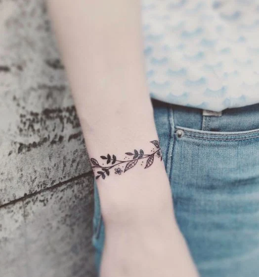 flower tattoo around wrist