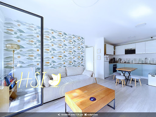 Living room with sofa and open kitchen in this luxury apartment / penthouse for sale in Bois-Colombes ($471,009 - 59 m²)