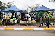 ANC supporters look at memorabilia on sale before making their way in, 08 January 2022, at the Peter Mokaba Stadium in Polokwane, Limpopo, where the political party celebrated their 110th birthday and delivered the annual January 8 statement.