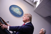 US President Donald Trump answers questions during the daily coronavirus task force briefing as Vice President Mike Pence listens at the White House in Washington, US, on April 3 2020. 