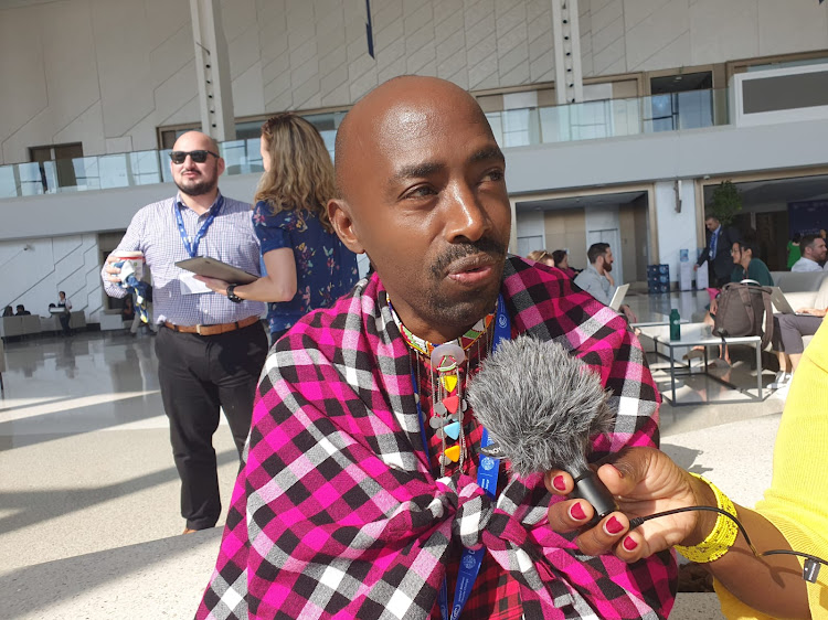 The President of the Indigenous Persons with Disability Global Network Manase Ntutu gestures during interview in Dubai. Image: Gilbert Koech.