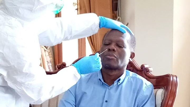 A medic collects samples for coronavirus testing