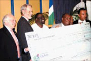 BRIGHTENING UP: Johannesburg mayor Amos Masondo, second from right, recives the cheque for R2,2million donated to fund tree-planting in Soweto. With him are, from left, Danish ambassador Torben Brylle, Norwegian ambassador Ove Thorsheim, James Murombedzi and Luther Williamson of Joburg City Parks. Pic. Mbuzeni Zulu. 06/12/2006. © Sowetan.