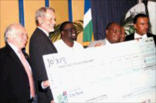 BRIGHTENING UP: Johannesburg mayor Amos Masondo, second from right, recives the cheque for R2,2million donated to fund tree-planting in Soweto. With him are, from left, Danish ambassador Torben Brylle, Norwegian ambassador Ove Thorsheim, James Murombedzi and Luther Williamson of Joburg City Parks. Pic. Mbuzeni Zulu. 06/12/2006. © Sowetan.