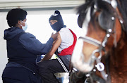 An 18-year-old from Manenberg on the Cape Flats received his vaccine after arriving at the Athlone Stadium drive-through in a horse and cart . File photo.