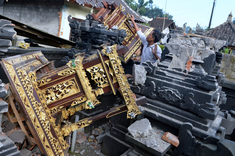 A man is seen among damaged buildings of a temple after a 4.8 magnitude earthquake struck northeast of Bali, in Karangasem, Bali, Indonesia on October 16, 2021.
