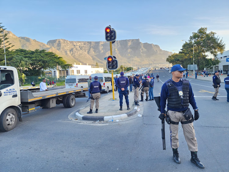 Cape Town metro police officers keep an eye on the scene after clashes with taxi drivers. Picture: CITY OF CAPE TOWN