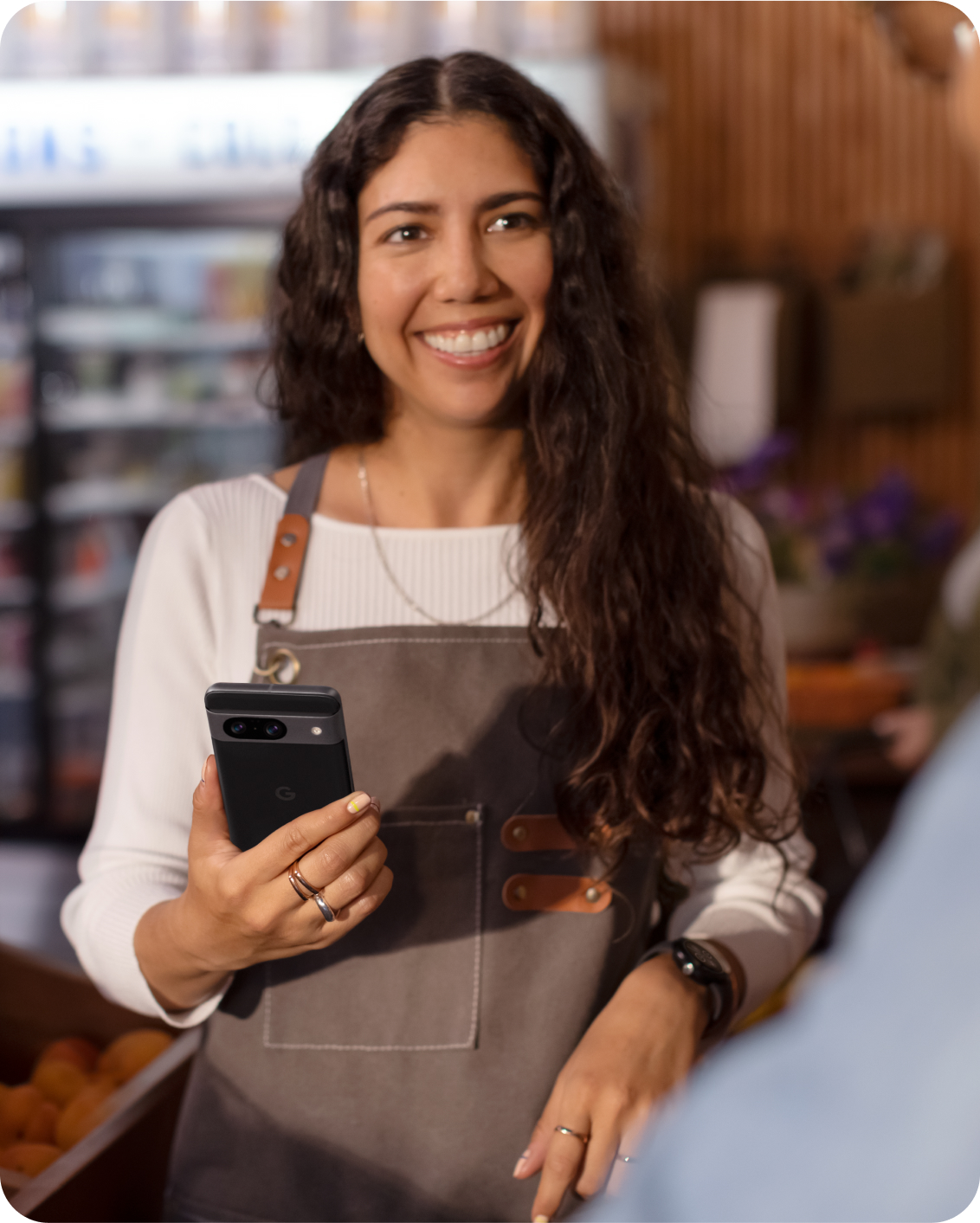 A woman working on a Google 8 Pro phone in her shop.