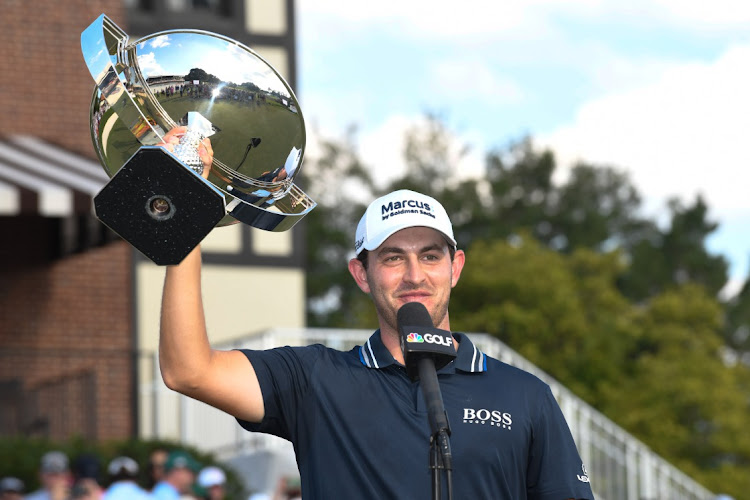 Patrick Cantlay holds up the trophy after winning the Tour Championship