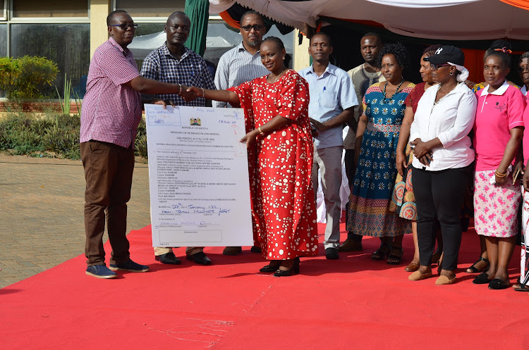 Members of the Taita Taveta Artisanal Miners Associations receive a dealers’ licence from Governor Granton Samboja’s wife Stella in Voi on Tuesday