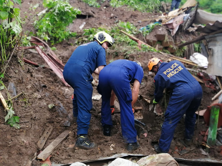 Paramedics work through the rubble after a house collapsed in Inanda, north of Durban, on Thursday morning.