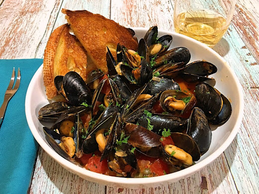 A bowl of Moules (Mussels) à la Provençale along with some toasted bread to sop up the sauce.