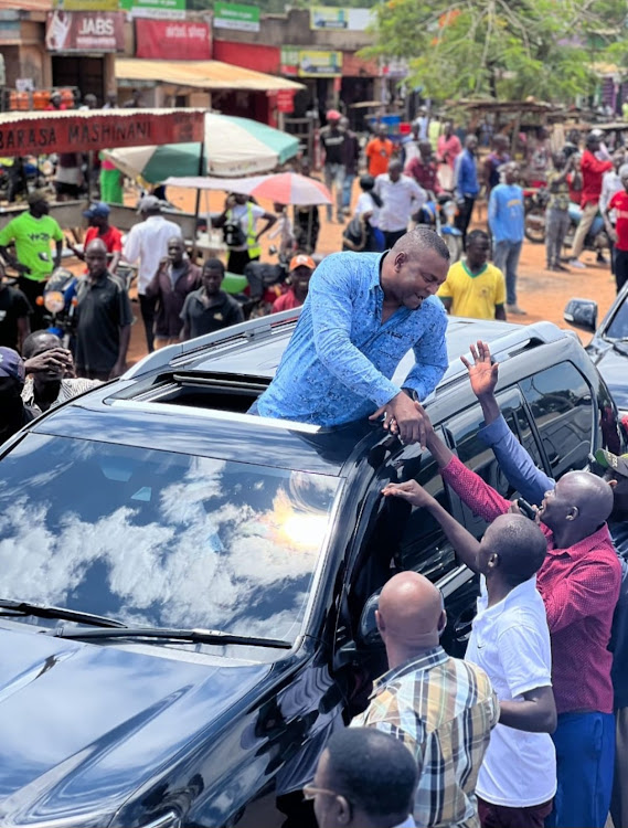 Former Sports Cabinet Secretary Rashid Echesa greets area residents in Mumias on April 12, 2024.