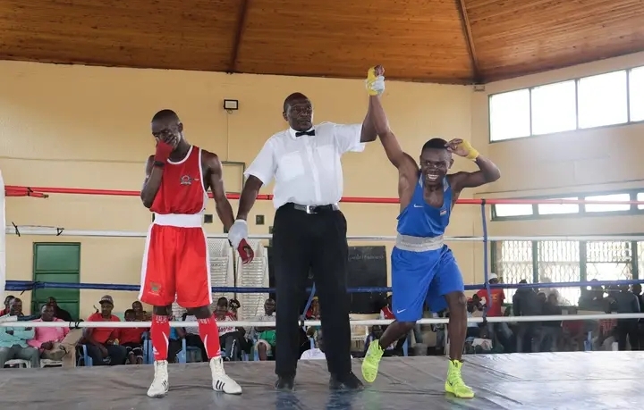 Kibra's Paul Omondi (right) celebrates his victory over Dennis Muia of Kenya Police during the bantamweight finals of the national trials at Jericho Social Hall in Nairobi.