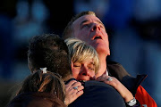 Lynn and Christopher McDonnell, the parents of seven-year-old Grace McDonnell, grieve near Sandy Hook Elementary after learning their daughter was one of 20 school children and six adults killed after a gunman opened fire inside the school in Newtown, Connecticut, U.S. on December 14, 2012. 