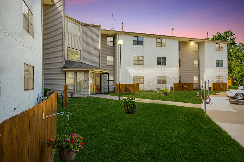 Ridgewood Hills apartment building with light siding at dusk