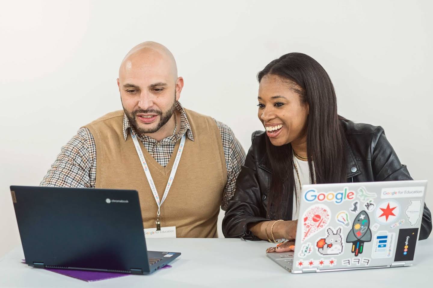 Image of two educators collaborating together on Chromebooks