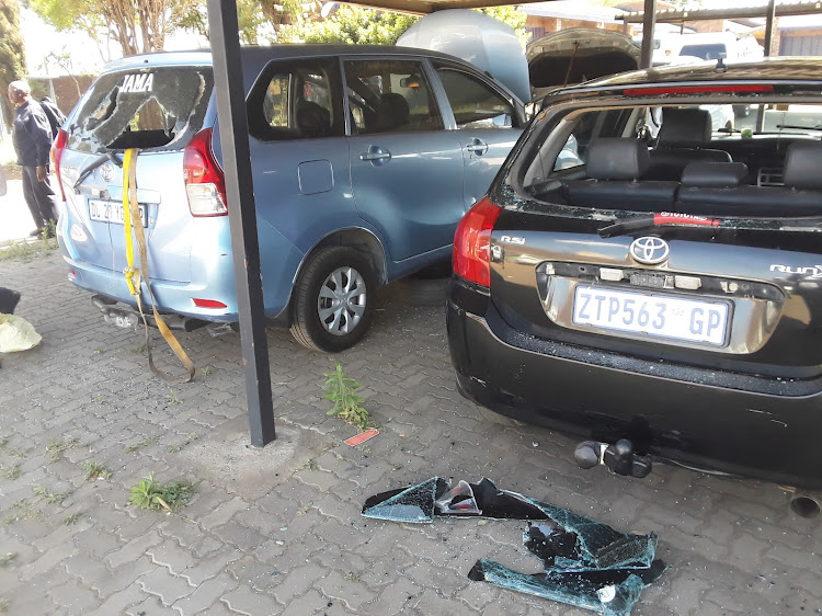 Three security officials were attacked and at least 15 cars were damaged when a group of people stormed and vandalised a City Power depot in Klipspruit, Soweto, on Wednesday.