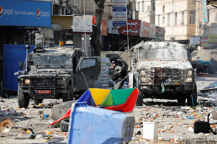 An Israeli security forces member clashes with Palestinians during a raid in Nablus in the Israeli-occupied West bank, February 22 2023. Picture: RANEEN SAWAFTA/ REUTERS