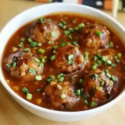 Vegetable Dumpling Tossed In Manchurian Sauce