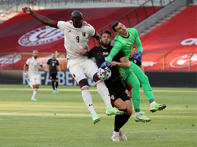 Croatia's Dominik Livakovic and Duje Caleta-Car in action with Belgium's Romelu Lukaku