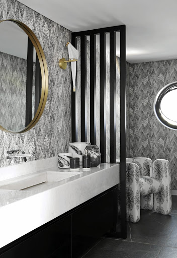 The monochromatic guest bathroom is enveloped in Romo's Itsuki wallpaper.