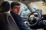 Max Verstappen seems to have a less aggressive, stylish stance when behind the wheel of cute electric hatchbacks.   