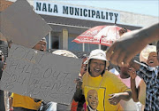 IN PROTEST: ANC members and Bothaville residents demonstrate outside the Nala municipality offices in January. They are demanding the removal of all officials implicated in the damning KPMG forensic report.  Photo: ANTONIO MUCHAVE