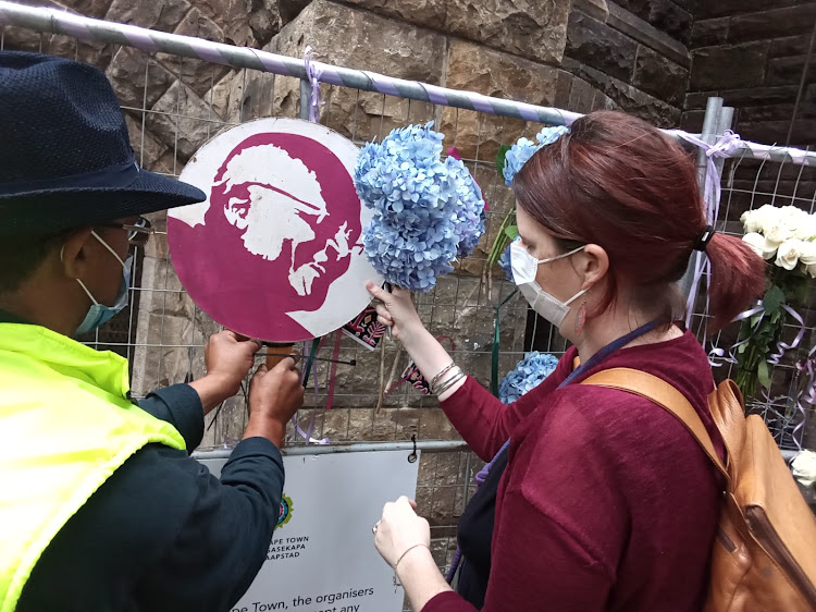 Ellie Shortall placed a board with Archbishop Emeritus Desmond Tutu's face at St George's Cathedral in Cape Town on Monday. She collected the board a few years ago during a peace march in Cape Town