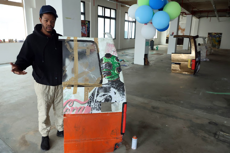 Mncedi Madolo with his art work at Asisebenze Art gallery in Johannesburg .