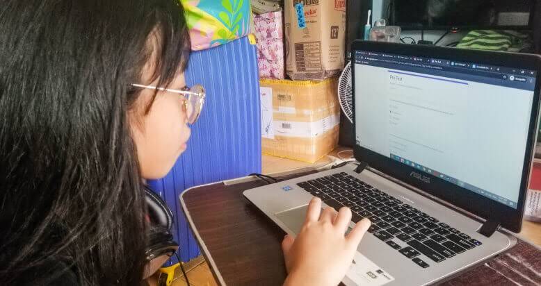 A female student doing a pre-test practice Google Form with her Chromebook at home.