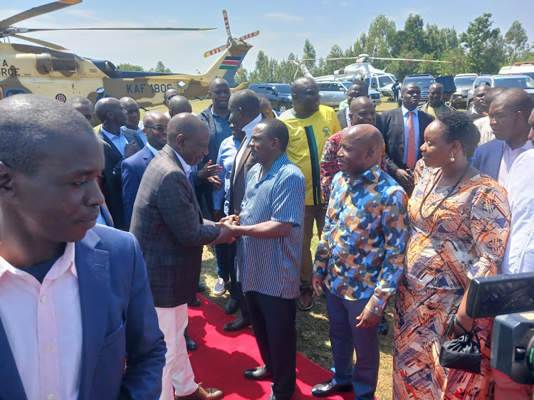 President William Ruto greets Gem MP Elisha Odhiambo after arriving to grace the thanksgiving ceremony of PS Interior Raymond Omollo