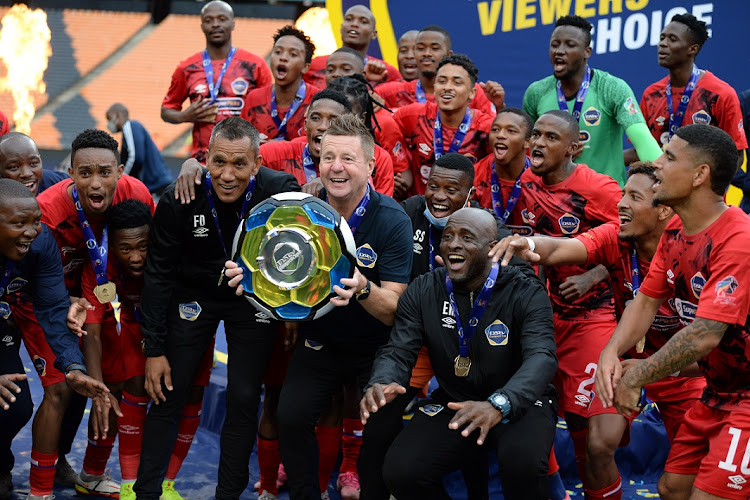 Warriors coach Dylan Kerr and his players celebrate winning the DStv Compact Cup final against Coastal United at FNB Stadium on January 29 2022.