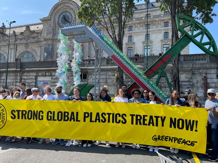 Actor Shailene Woodley and activists hold a banner as Greenpeace International unveils an art installation by artist Benjamin Von Wong, ahead of a four-day summit of the UN Environment Programme on reducing plastic pollution, in Paris, on May 27 2023. Picture: REUTERS/MICHAELA CABRERA