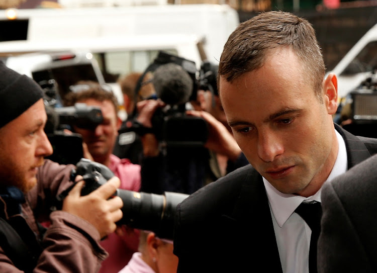 Oscar Pistorius, right, arrives ahead of his trial for the murder of his girlfriend Reeva Steenkamp, at the North Gauteng High Court in Pretoria on April 16 2014. Picture: REUTERS/SIPHIWE SIBEKO