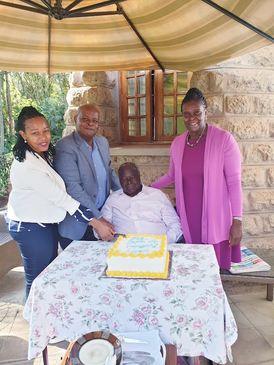 Mwai Kibaki(seated), Jimmy Kibaki and his wife Caroline Wangui and daughter Judy Kibaki cut a cake at the former President Mwai Kibaki's 90th birthday in a small family gathering at his Muthaiga home.