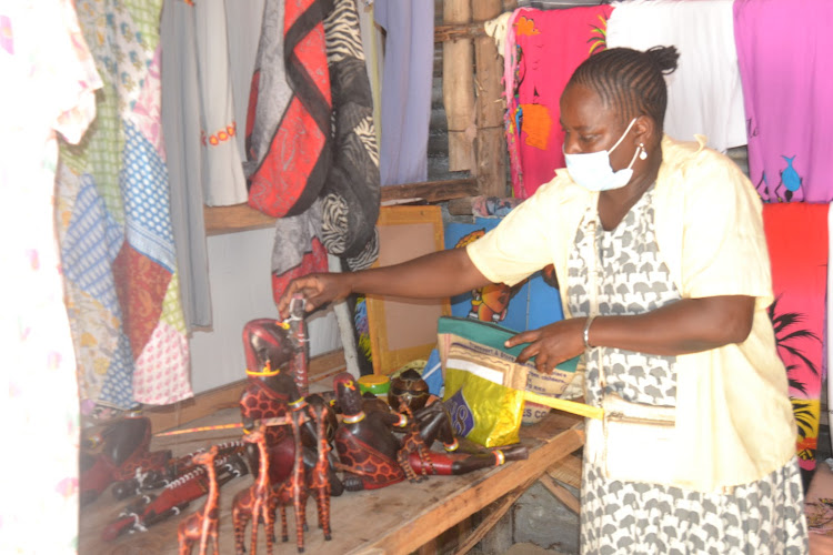 Kadzo shows the products they sell to tourists in Malindi