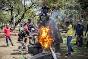 Students vandalise the statue of Charles Robberts Swart on February 23, 2016 at the University of Free State in Bloemfontein. Picture Credit: Gallo Images