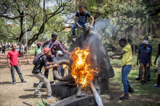 Students vandalise the statue of Charles Robberts Swart on February 23, 2016 at the University of Free State in Bloemfontein. Picture Credit: Gallo Images