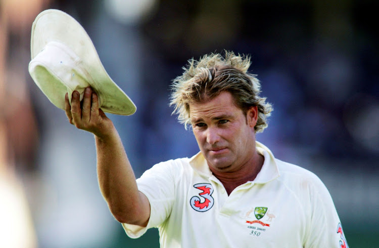 Australia's Shane Warne acknowledges the crowd after the wicket of England's Andrew Flintoff during the fifthTest at Sydney Cricket Ground in the 2006-07 series against England.