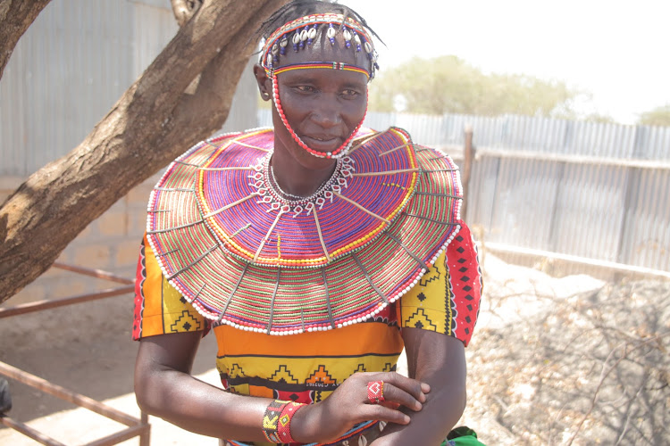 Cheptano Y'walasiwa, 48, shows some of the scars from beatings by her now dead husband.