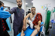 A Palestinian injured in Israeli air strikes is treated at Kuwait Hospital on January 08, 2024 in Rafah, Gaza. Despite Israel's recent troop drawdown in Gaza and the discussion of postwar plans by an Israeli cabinet minister, the country has continued its intensive bombardment of the Gaza Strip, particularly in the territory's south, as it seeks to destroy Hamas, the Palestinian militant group behind the Oct. 7 attacks.