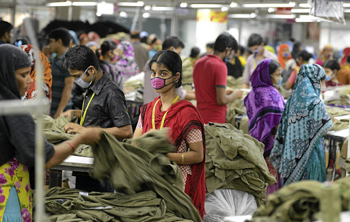 Workers in a Bangladeshi clothing factory. Industry workers protest a wage offer that is only half of their demand, as it is not enough to live on.