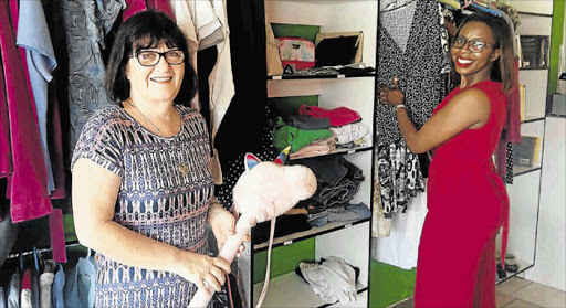 AFFORDABLE SHOPPING: Christelike Maatskaplike Raad (CMR) manager Gaye Moonieya, and the organisation’s marketer, Nwabisa Dlabati, unpack second-hand donations to stock the new Out of the Box charity shop in Old Transkei Road, Nahoon, which will help fund CMR’s welfare work Picture: BARBARA HOLLANDS
