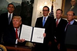 US President Donald Trump finishes signing a memorandum directing the US trade representative to complete a review of trade issues with China, at the White House, on August 14 2017. Picture: REUTERS