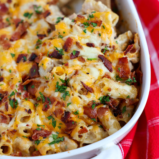 This Chicken Bacon Ranch Casserole is loaded with golden brown chicken pieces, crisp smoked bacon, alfredo sauce, ranch seasoning, pasta, and a generous helping of mozzarella and cheddar cheese. 