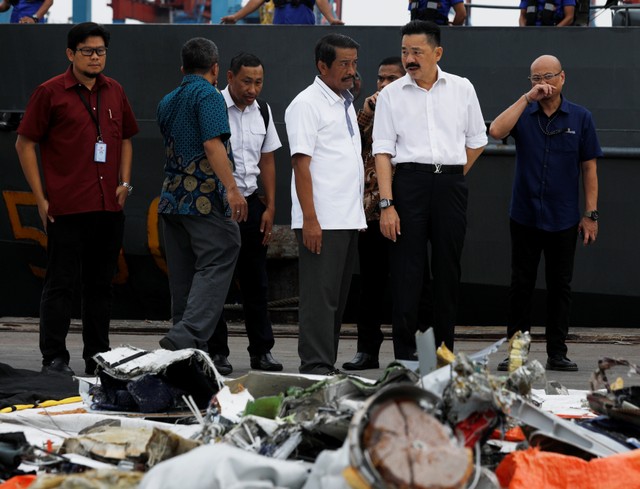 Lion Air CEO Edward Sirait (center L) and owner Rusdi Kirana (center R) inspect the recovered debris of Lion Air flight JT610 at Tanjung Priok port in Jakarta, Indonesia, October 30, 2018.